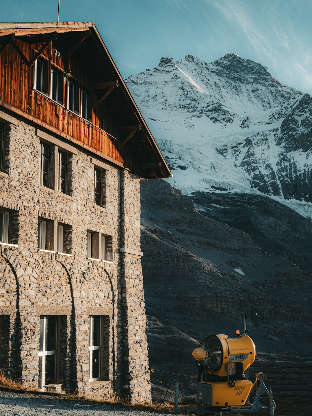 Filmmaker shooting a travel video in the Swiss Alps with a gimbal
